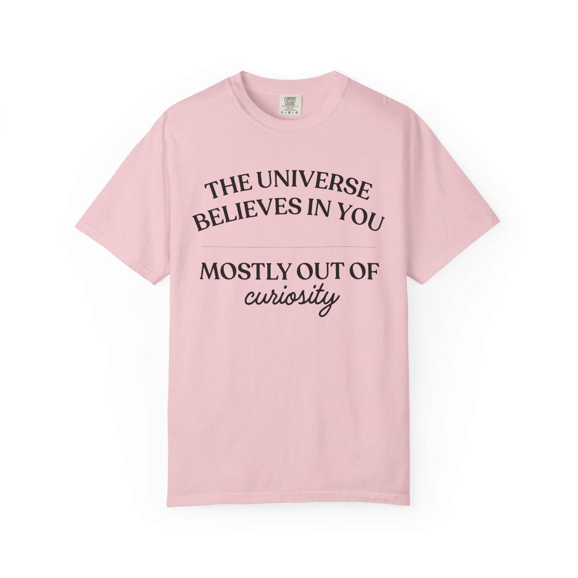Light pink Comfort Colors graphic tee with black text: The Universe Believes in You, Mostly Out of Curiosity, Youniverses fashion.