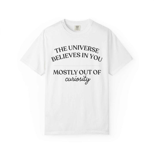 White Comfort Colors graphic tee with 'The Universe Believes in You Mostly Out of Curiosity' text