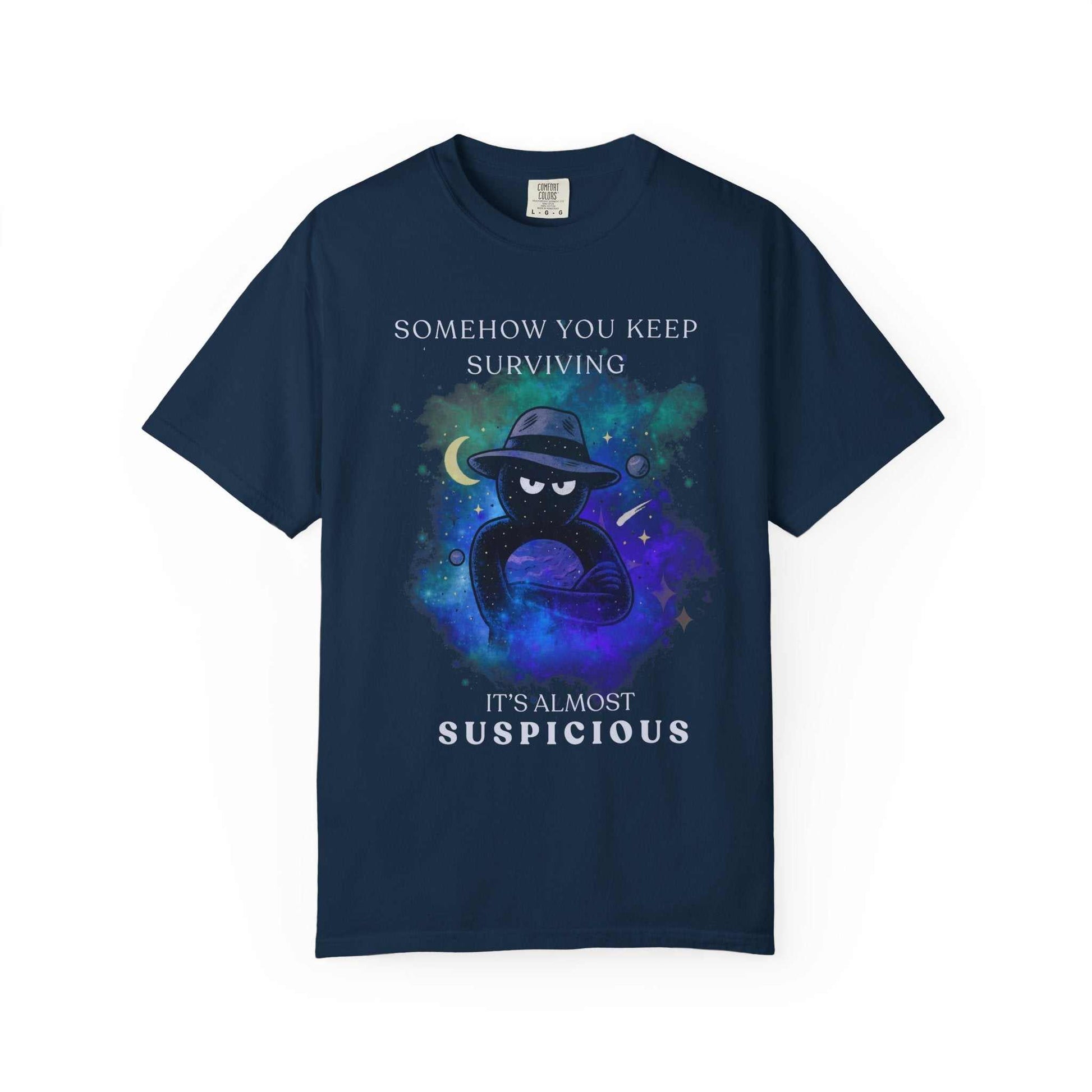 Navy t-shirt with galaxy background, mysterious figure, and text 'Somehow you keep surviving, it's almost suspicious' from Youniverses.